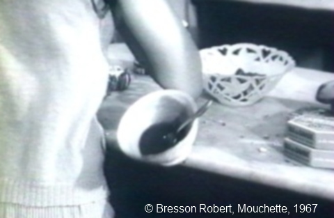 Photogramme : "Mouchette". Une habitante du village invite Mouchette à prendre un bol de café, plus par curiosité que par compassion.